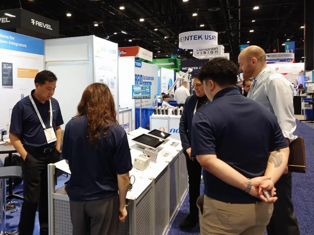NODKA team discussing industrial control, panel PC, and edge AI automation solutions with visitors at Automate 2026
